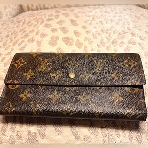 Louis Vuitton International Wallet in monogram logo.